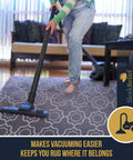 Person vacuuming area rug using Non Slip Rug Lock Grip For Hard Floors Keeps Area Rugs From Sliding With Cushioned Padding