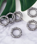Six Pack Bicycle Crank Bearing Set 5/16 Inch 7 Balls 38 OD 24 ID 8 MM Ball Size on marble surface with leaves