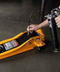 Using 18 Inch Flex Grease Gun Hose Extension with coupler on jack, showing flexible reach for hand and air-powered grease guns
