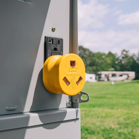 PowerGrip Heavy Duty RV 15 Amp Male To 30 Amp Female Electrical Adapter installed on outdoor socket
