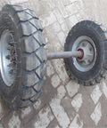 Beefed Up Heavy Duty Double Utility Pole Dolly With Two Wheel Concrete Pole Transport Cart For Electrical Crews Built Tough With Solid Steel Frame Easy Maneuver On Rough Job Sites And Heavy Poles. two thick pneumatic wheels on steel axle