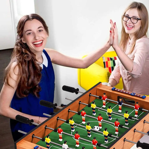 Two women enjoying a game on the 2 In 1 Swivel Mini Game Table Top Wood Foosball And Slide Hockey Combo.