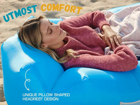 Person relaxing on blue Inflatable Couch Air Lounger Chair For Camping And Beach Trips Portable Blow Up Sofa at the beach.