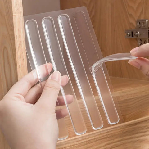 Hands holding and peeling off a clear silicone strip from a set of 100Pcs Self Adhesive Rubber Bumper Strips For Door Slam Prevention.