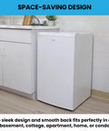 Hella Compact 3.1 Cubic Feet White Upright Freezer With Three Wire Baskets Garage Ready, positioned in a kitchen corner.