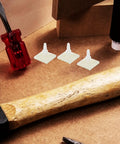 Self Adhesive PCB Standoffs With Hella Secure Insulated Foot Pads For Circuit Boards and Motherboards on a workbench with tools.
