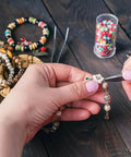 Hands using pliers and tweezers on necklace from One Stop Jewelry Making Kit With Open Jump Rings And Lobster Clasps 1200 Piece Set
