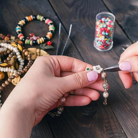 Hands using pliers and tweezers on necklace from One Stop Jewelry Making Kit With Open Jump Rings And Lobster Clasps 1200 Piece Set