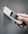 No Sweat Wall Patch Tube, High Strength Spackle With Built-In Applicator Wand being used on a wall to fill a nail hole.