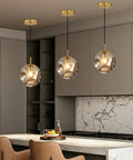Modern Smoke Gray Glass Globe Pendant Light 3 Pack, 7.87" Hardwired Brass Pendant with Adjustable 59" Cord above kitchen island.