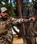 Archer aiming with Premium 30 Inch Carbon Hunting Arrows With Real 4 Inch Turkey Feather Fletching And Removable Tips in forest