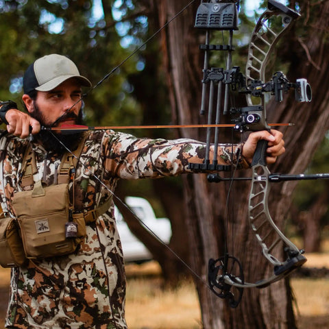 Archer aiming with Premium 30 Inch Carbon Hunting Arrows With Real 4 Inch Turkey Feather Fletching And Removable Tips in forest