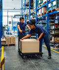 Two workers using Heavy Duty Folding Platform Cart, 1600 Lbs Capacity, to move boxes in a warehouse aisle.
