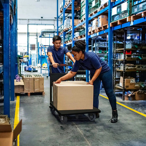 Two workers using Heavy Duty Folding Platform Cart, 1600 Lbs Capacity, to move boxes in a warehouse aisle.
