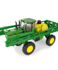 One Sixteen Scale Self Propelled Sprayer Toy That Feels Like The Real Deal With Functional Water Sprayer Lights And Sounds Boom Arms Span Forty Five Inches Realistic Farm Machine For Kids Ages Five And Up in green with extended boom arms and large wheels.