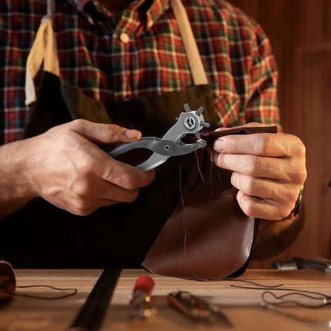 Person using Heavy Duty 9 Inch Leather Hole Punch Tool Rotary Belt Hole Puncher With Ergonomic Non Slip Handle to punch leather.