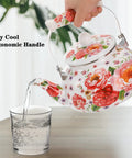 Person pouring water from Enamel Steel Tea Kettle Stovetop 2.6 Quart Large Porcelain Enameled Teakettle 2.5L Colorful Floral Design