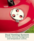 Close-up of a red 14 Inch Portable Charcoal Grill with Locking Lid and Dual Vents Lightweight Tabletop BBQ.