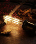Warm glowing Dimmable T10 LED Bulbs Warm White 2700K 6W Tubular Edison Style Lamps 60 Watt Equivalent 550LM on wooden surface