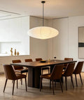 20 Inch Oval Paper Lantern Pendant Light White Rice Paper Ceiling Lamp Japanese Style diffused glow over a modern dining table.