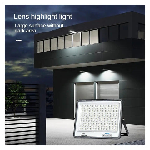 JUDYSSY High Brightness Led Flood Light 200W illuminating a dark outdoor area, showcasing its large surface design and brightness.