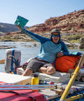 Person on raft holding All In One Camping Poop Kit 6 Pack With Odor Control Poop Powder Smell Proof Disposal Bags on river trip