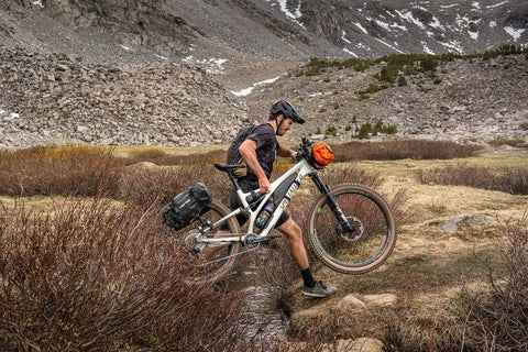 Cyclist with Spider Rear Rack And Bar Cradle For MTB And eMTB Quick Release Bike Rack System Built For Any Adventure in rugged terrain