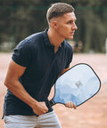 Man playing pickleball with Lightweight Fiberglass Pickleball Paddles Set Of 2 With Honeycomb Core And Grippy Handle For Superior Spin And