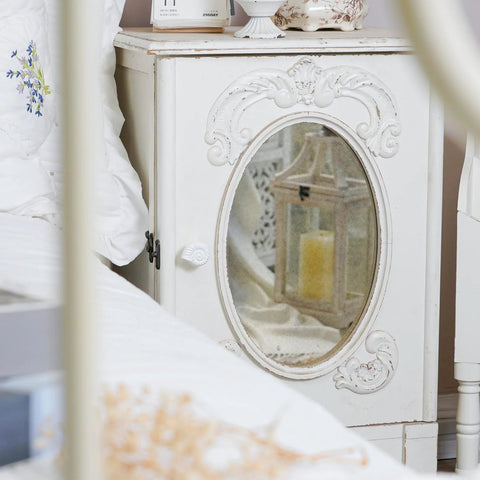 Antique white cabinet with oval mirror featuring Six Pack Resin Beach Conch Cabinet Knobs in a bedroom setting