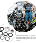 Mechanic working on a dirt bike with parts from 7 Pack Mini Dirt Bike Steering Shaft Bearings Kit for Off Road Rides.