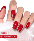 Hand with glossy nails painted Dope Big Apple Red Gel Polish Salon Grade 0.5 Fl Oz Soak Off UV LED Cure For 60 To 90 Seconds Safe Low Odor HEMA Free And TPO Free Nail Lacquer For Fall Winter Nail Art For Women And Girls against white fabric backdrop.