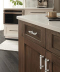 Kitchen view with Glacio Clear Satin Nickel Cabinet Pull 3 Inch Center To Center, 4-9/16 Inch Overall Length, installed on dark wood cabinets.