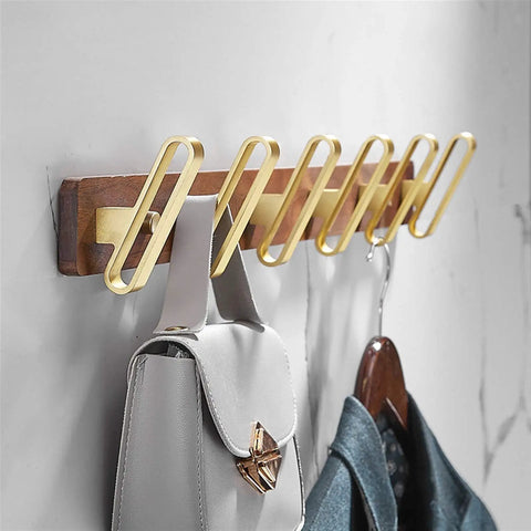 Heavy Duty Solid Wood Double Coat Hook With Sleek Brushed Gold Finish Wall Mounted Robe Rack holding bags and jackets.