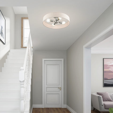 Four Light Bronze Semi Flush Mount With Antique Brass Accents And Oatmeal Fabric Shade, installed in hallway.