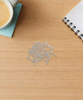 50 Pack Small Ballpoint Pen Compression Springs Pro Grade 0.78 Inch Stainless Steel on desk with coffee and notepad