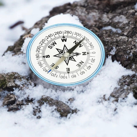 Must-Have 100mm Large Pocket Compass For Camping And Hiking on snowy rock
