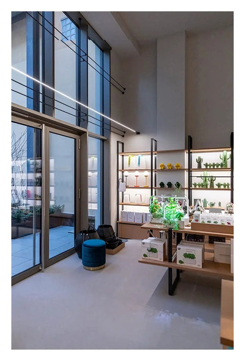 Effortlessly Sleek Modern Linear LED Wall Sconces With Remote Control For Cozy Bedroom And Living Room Vibes A Total Game Changer For Your Glow Up In Black Finish Dimmable Lighting in a stylish modern interior with shelves and plants.