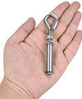 A hand holding a single heavy duty 304 stainless steel eyebolt, part of the Four Pack Expansion Eyebolt Anchors For Concrete Walls set.