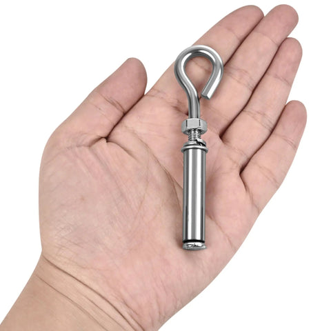 A hand holding a single heavy duty 304 stainless steel eyebolt, part of the Four Pack Expansion Eyebolt Anchors For Concrete Walls set.