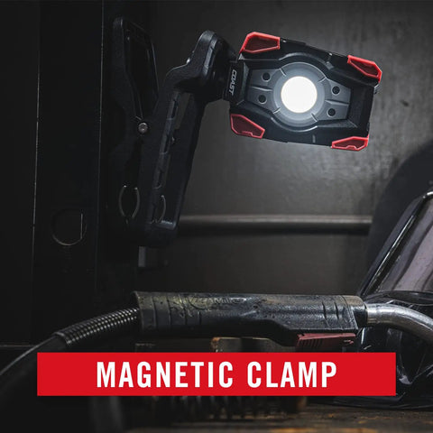 Rechargeable Dual Power LED Work Light With Magnetic Clamp, black red light clamped to metal surface, illuminating workspace