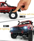 Off Road RC Truck One Sixteen Scale Beast with Proportional Steering, showing tire flexibility and LED lighting, red