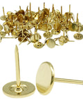 Close-up of Real Deal Gold Flat Head Thumb Tacks One Hundred Pack Killer Quality Solid Metal Drawing Pins for craft and upholstery use.