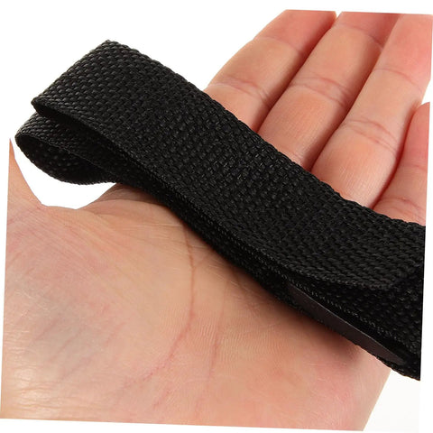 Close-up of a black strap from the Eight-Piece Adjustable Lawn Aerator Shoes Straps for Garden Spiked Sandals on a hand.