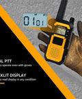 Badass Portable Waterproof Two Way Radio Featuring Rock Solid IP67 Protection And Snappy USB C Charging built tough for outdoor use, showing backlit display and gloves.