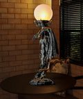 Gothic Dragon Sword Statue Table Lamp With Glowing Orb, Medieval Mythic Guardian Resin Decor for home, on a table in dim light