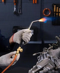 Person using Air Acetylene Torch Kit With 149 Inch Hose, Two Welding Tips, CGA200 Regulator And Torch Handle For Home DIY Projects