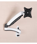 Desk Clearing Wall Mount Monitor Arm With Butter Smooth Mechanical Spring Adjustment Fits 12 To 27 Inch Screens mounted on a wall.