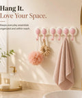 Hassle Free Peel And Stick Wall Hooks With Six Swiveling Rotating Arms For Hanging Bath Towels Kitchen Tools And Daily Gear Directly On Any Smooth Surface, mounted on a bathroom wall.