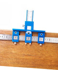 Straight Shot Precision Adjustable Woodworking Jig For Cabinet Hardware Portable Hole Punch Locator on wood surface with rulers