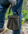 Person holding Canvas Tapered-Bottom Tool Bucket With Two Interior Pockets And Snap Clip Made From No 10 Canvas 8 Inch High